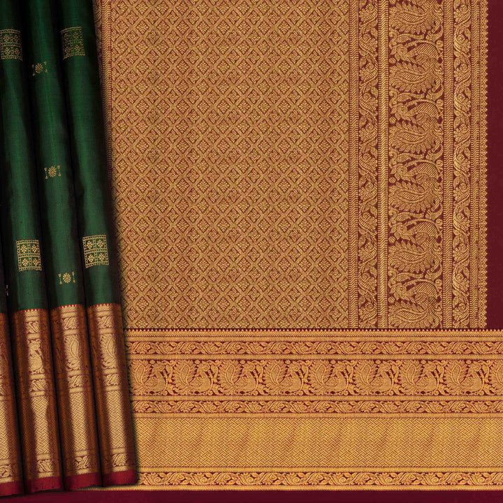 Traditional saree with green and gold patterns on a red background