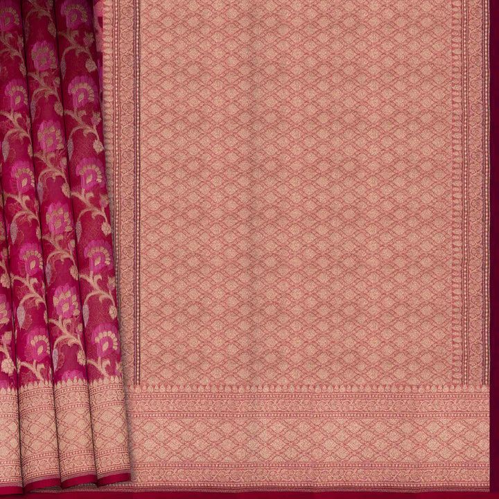 Pink saree with floral patterns on a plain background