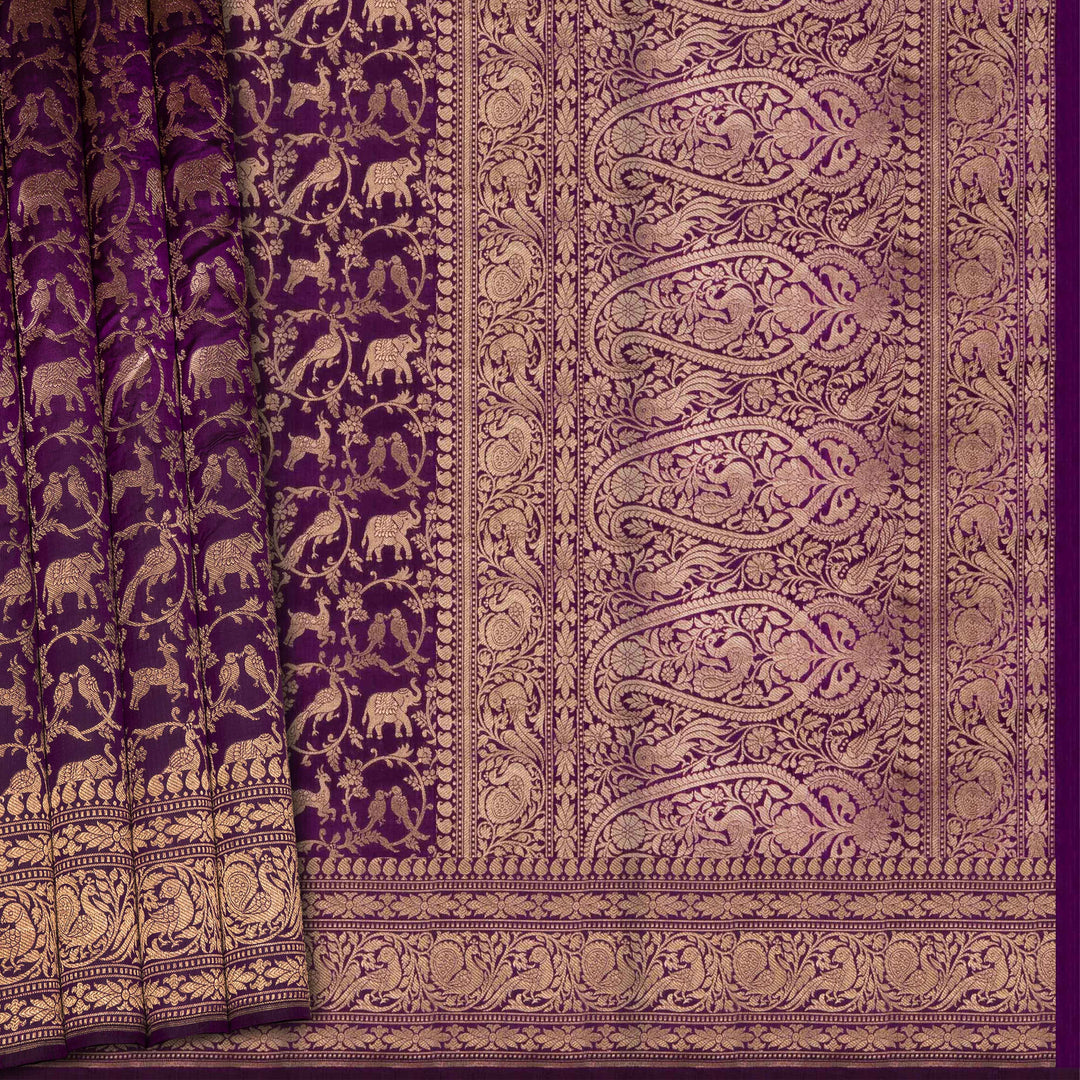Purple fabric with intricate gold patterns and elephant designs