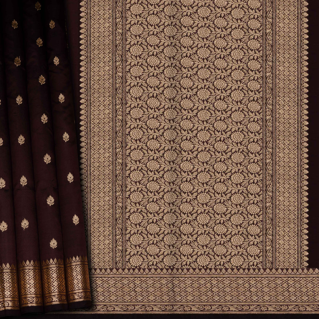 Brown fabric with intricate gold patterns on a dark background