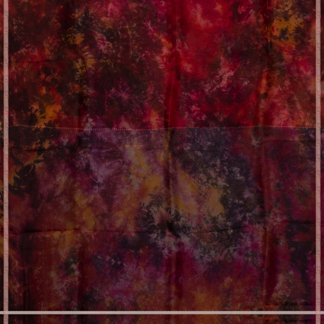 Body closeup of Handwoven maroon organza silk saree with abstract multicolour patterns and zari-lined border.