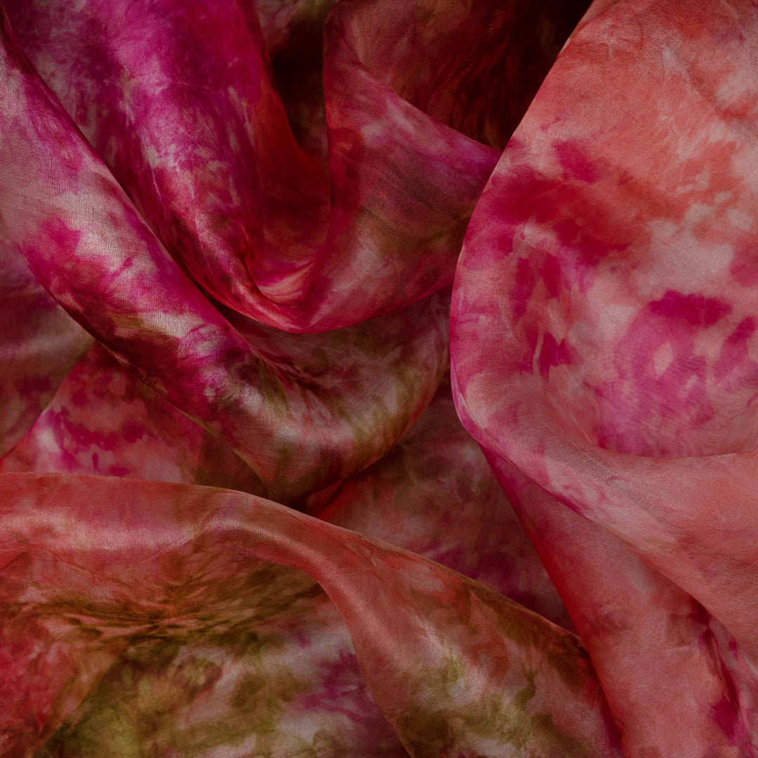 Closeup of Handwoven pink organza silk saree with multicolour abstract patterns.