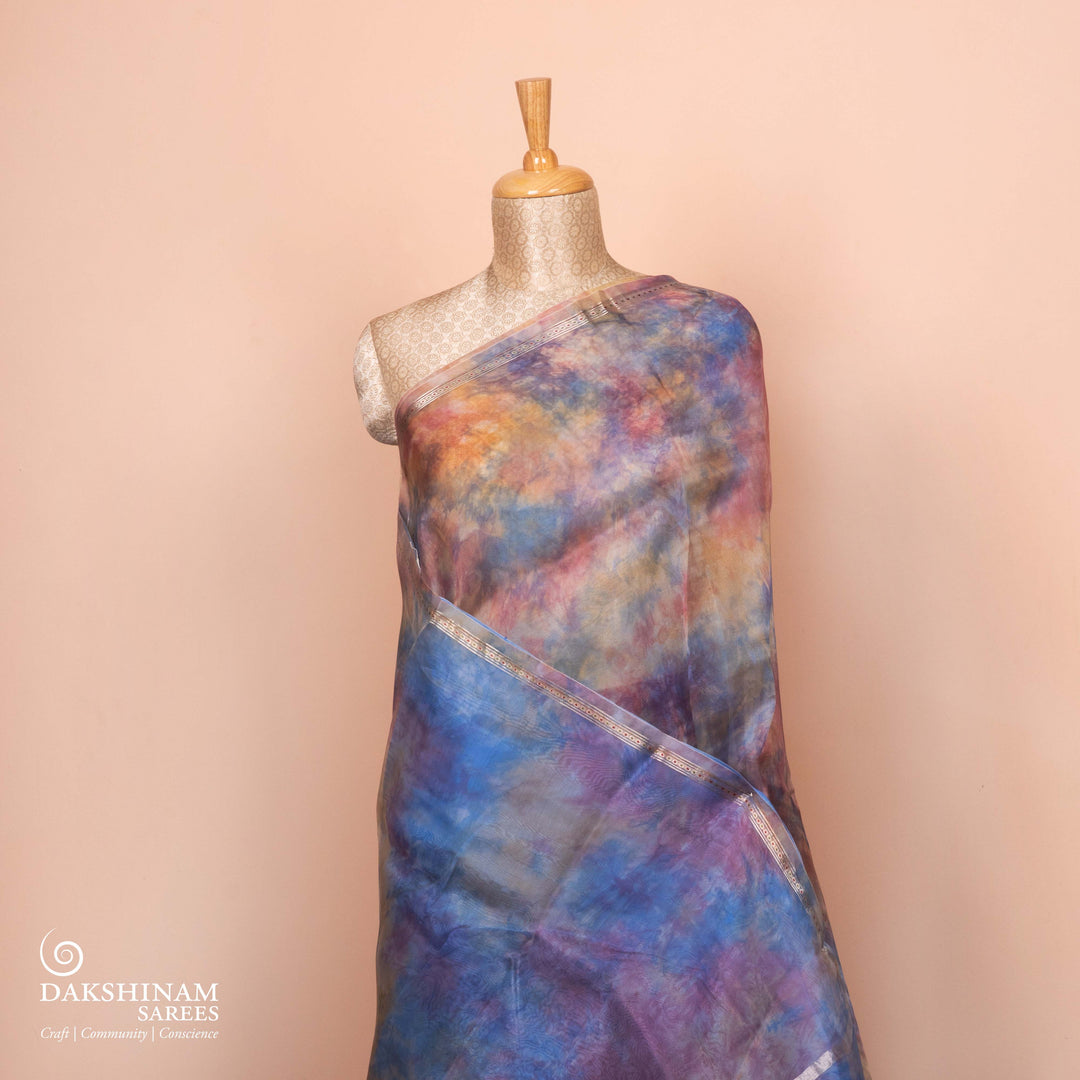 Full view of a Handwoven organza silk saree in sky blue with multicolour abstract strokes.