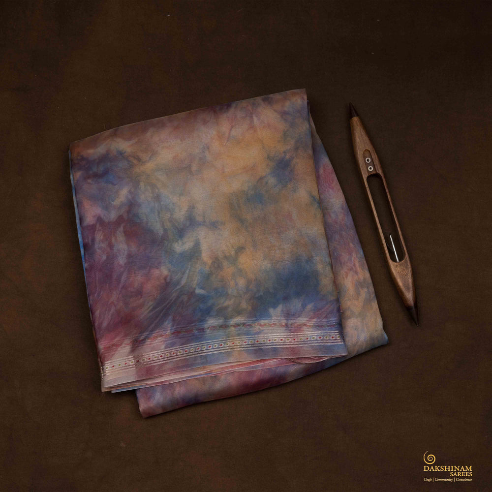 Closeup view of a Handwoven organza silk saree in sky blue with multicolour abstract strokes.