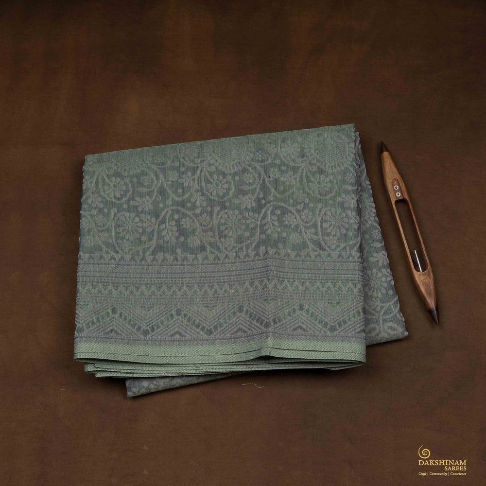 Closeup view of Handwoven grey South cotton saree with floral vines.