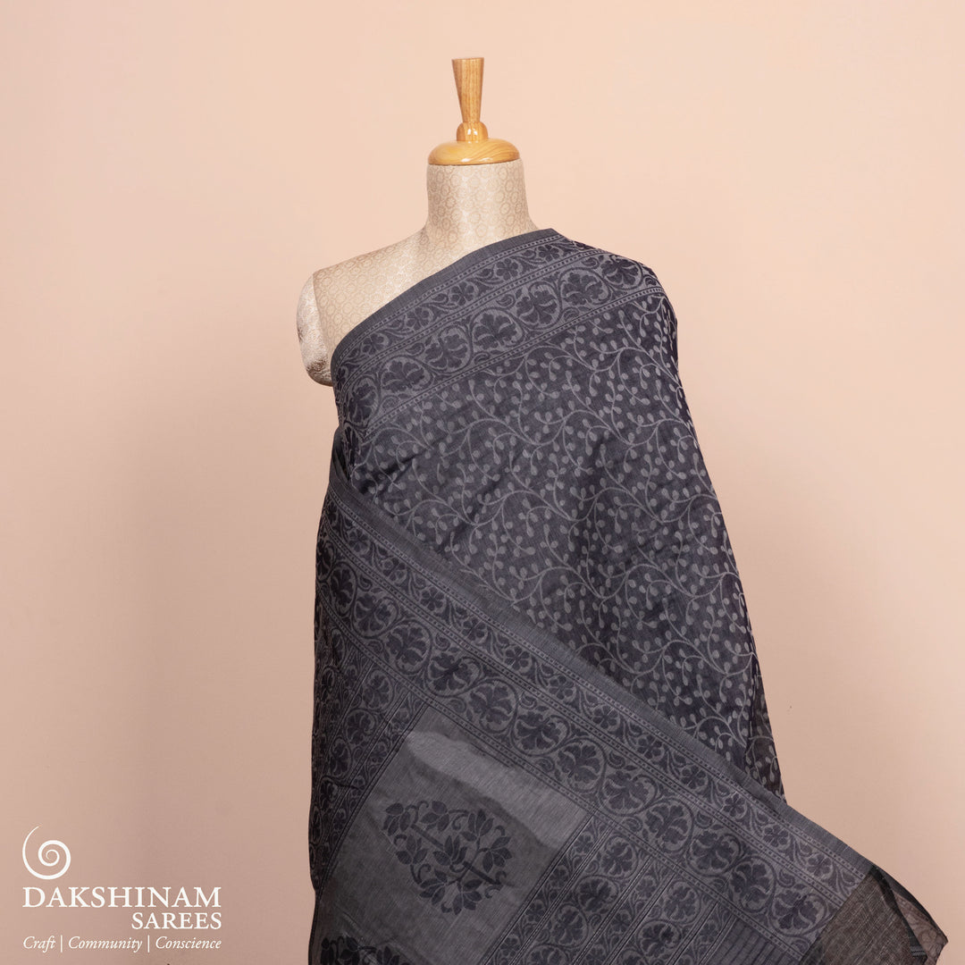 Full body view of a Authentic grey South cotton saree with floral vines, stripes and plant motifs.
