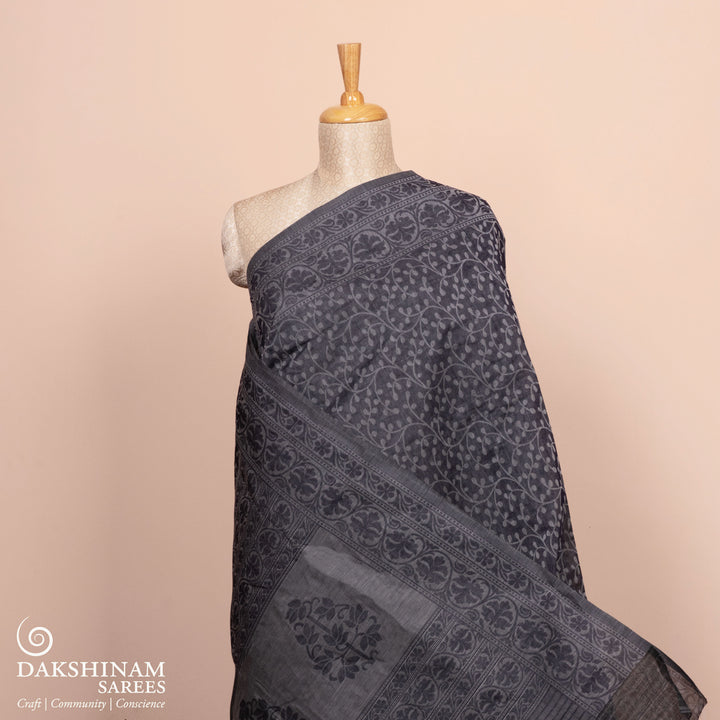 Full body view of a Authentic grey South cotton saree with floral vines, stripes and plant motifs.