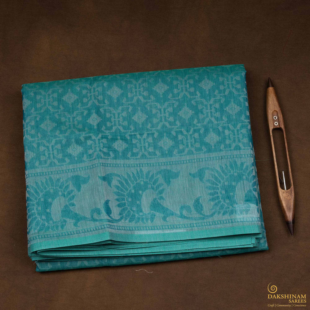 Closeup view of a Handwoven aqua blue South cotton saree with diamond-shaped patterns.