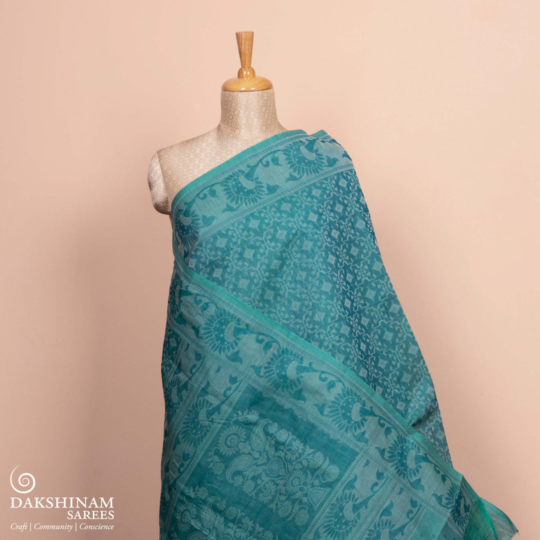 Full body view of a Handwoven aqua blue South cotton saree with diamond-shaped patterns.
