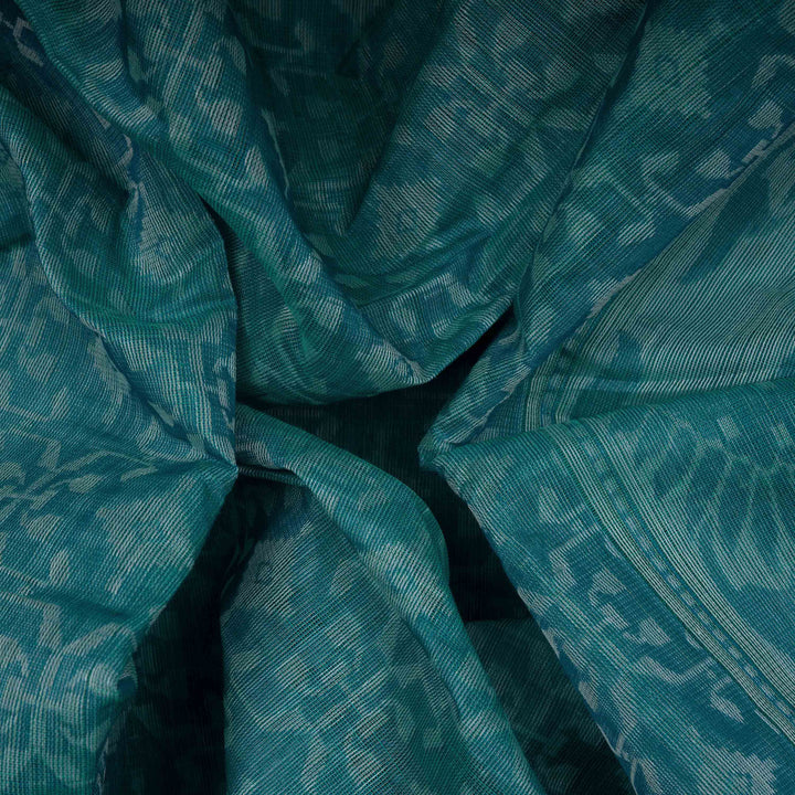 Closeup o a Handwoven aqua blue South cotton saree with diamond-shaped patterns, sunflower and leafy motifs, monotone border.