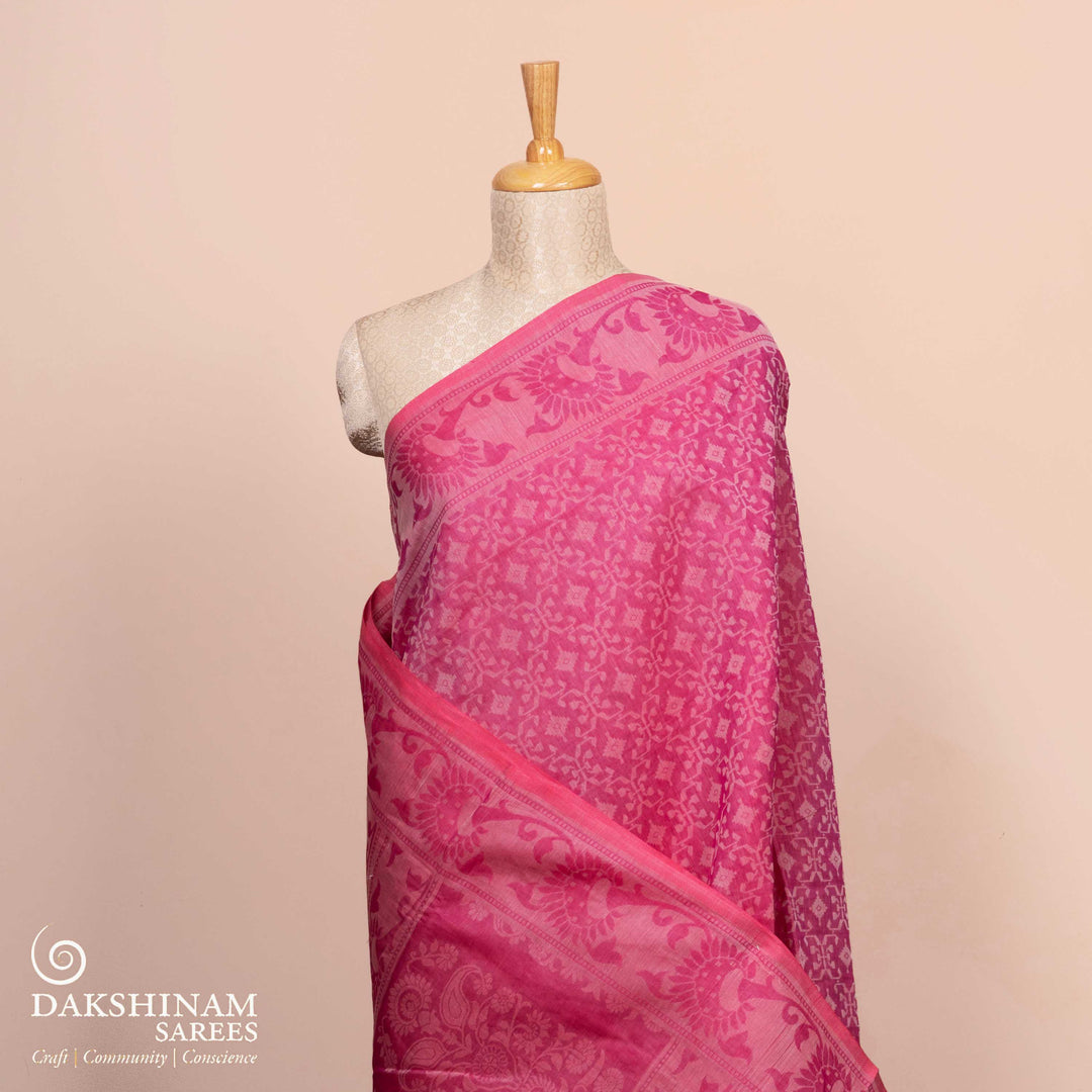 Full body view of a Authentic pink South cotton saree with diamond patterns.