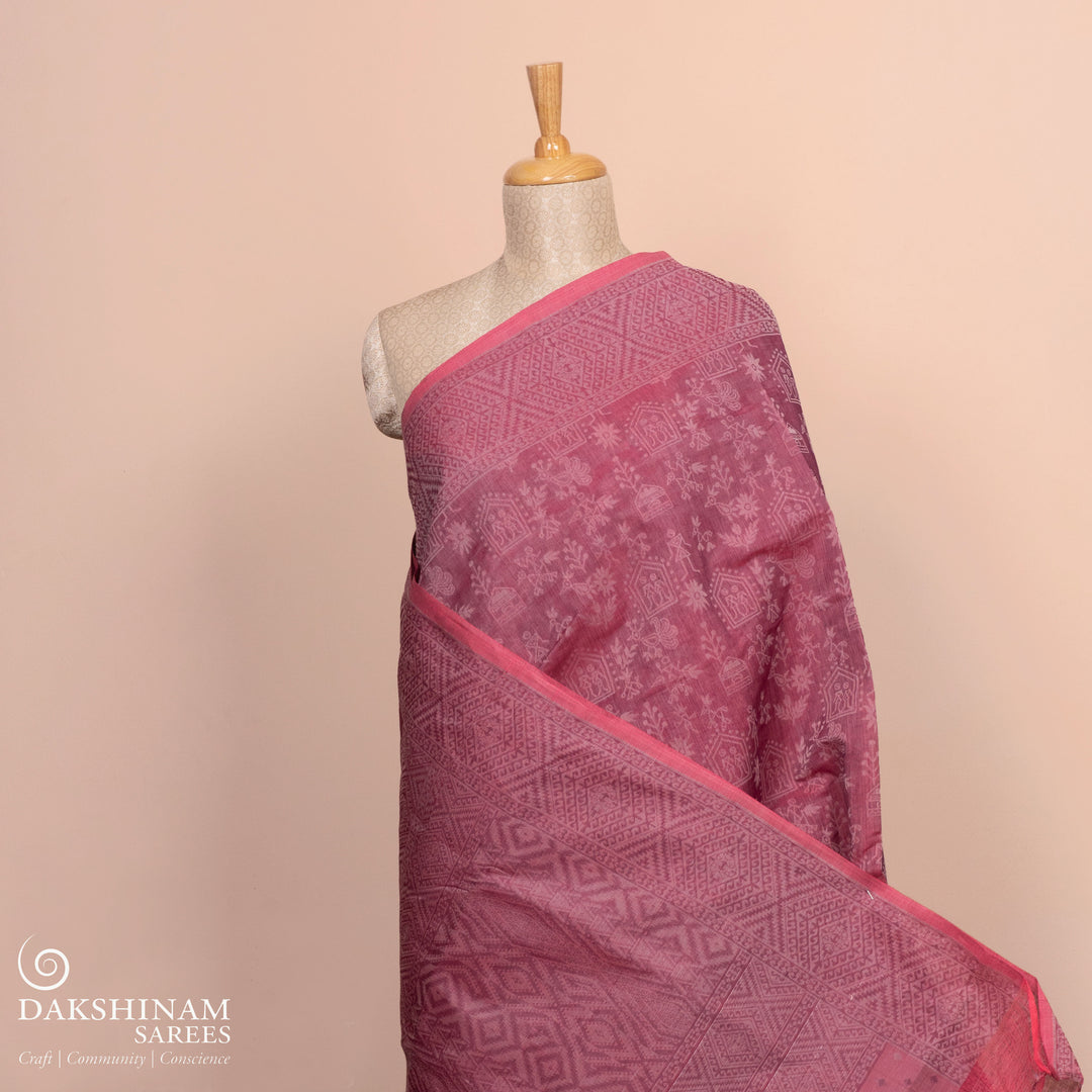 Full body view of a Authentic pink South cotton saree with hut motifs.