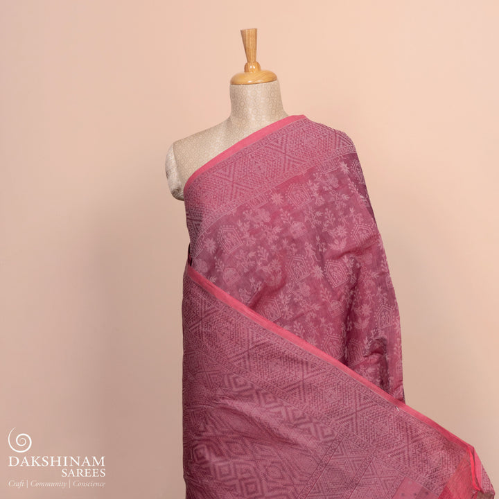 Full body view of a Authentic pink South cotton saree with hut motifs.