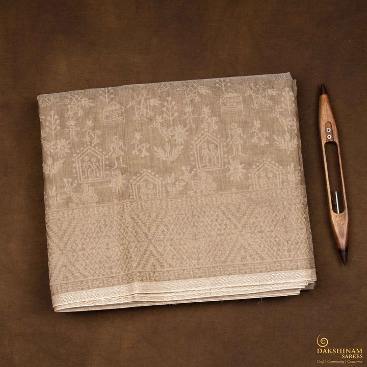 Closeup view of a Authentic beige South cotton saree with hut-shaped motifs, birds, diamond patterns, and stripes with monotone border.