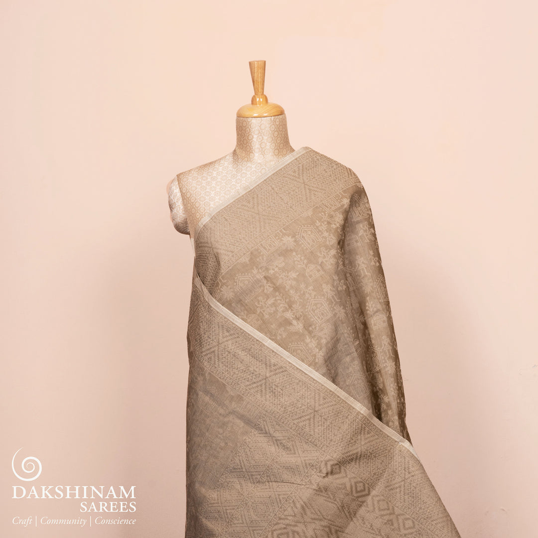 Full view of a Authentic beige South cotton saree with hut-shaped motifs.