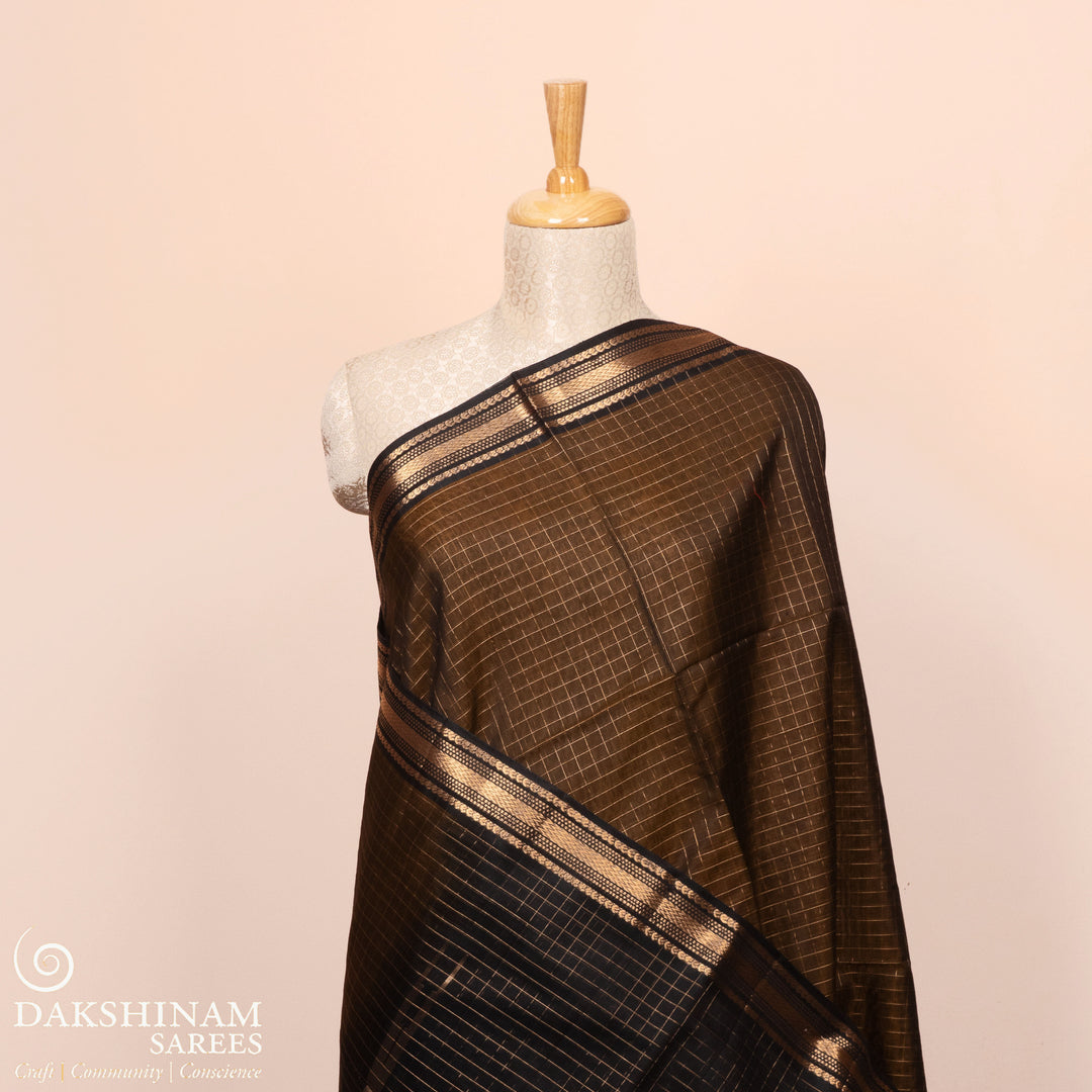 Full view of a Lightweight moss brown silk cotton saree with black gold zari border, checks, paisleys, temple and chevron motifs.