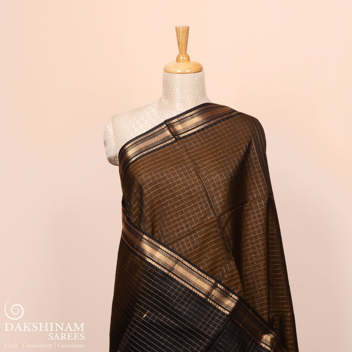 Full view of a Lightweight moss brown silk cotton saree with black gold zari border, checks, paisleys, temple and chevron motifs.