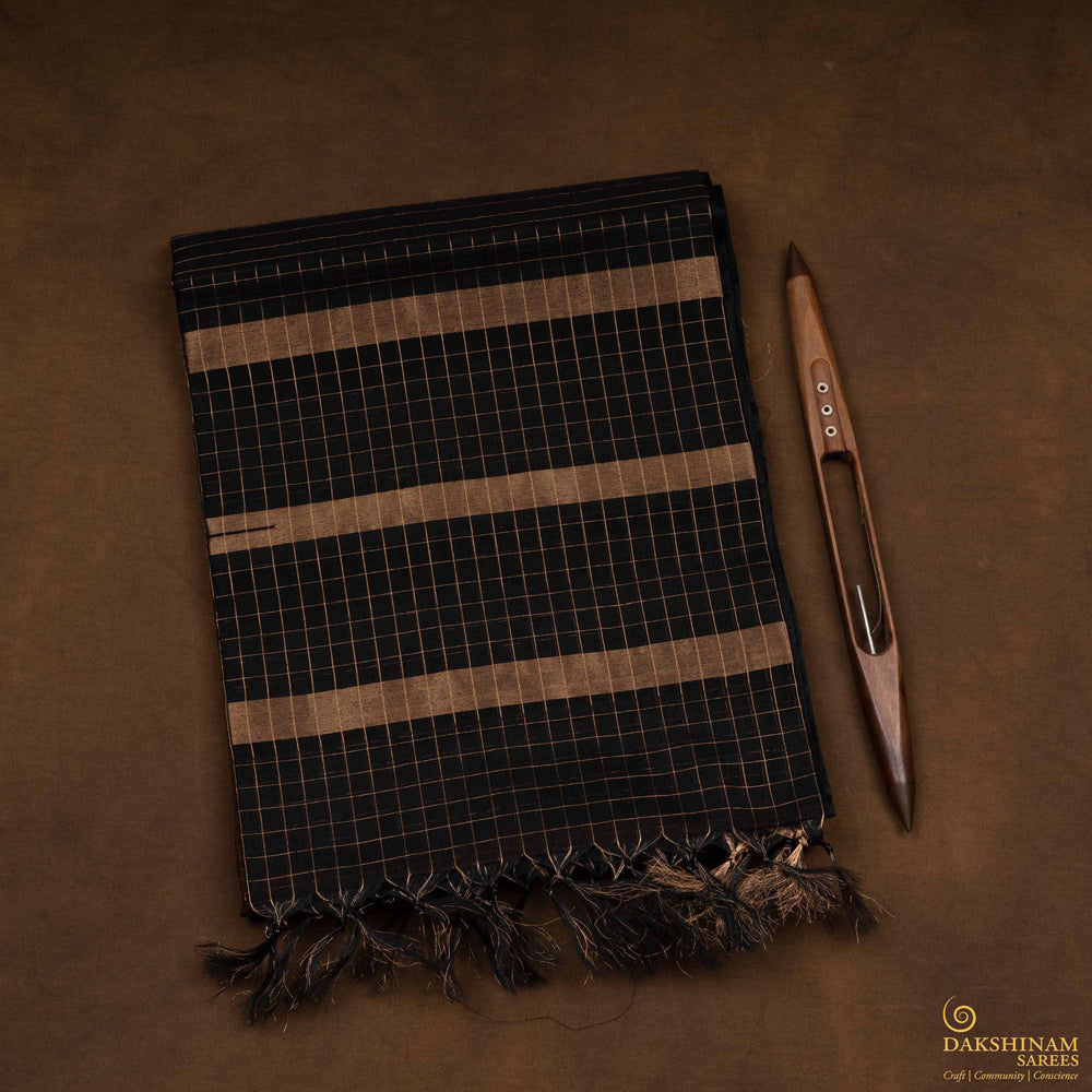 Closeup view of a Lightweight moss brown silk cotton saree with black gold zari border, checks, paisleys, temple and chevron motifs.
