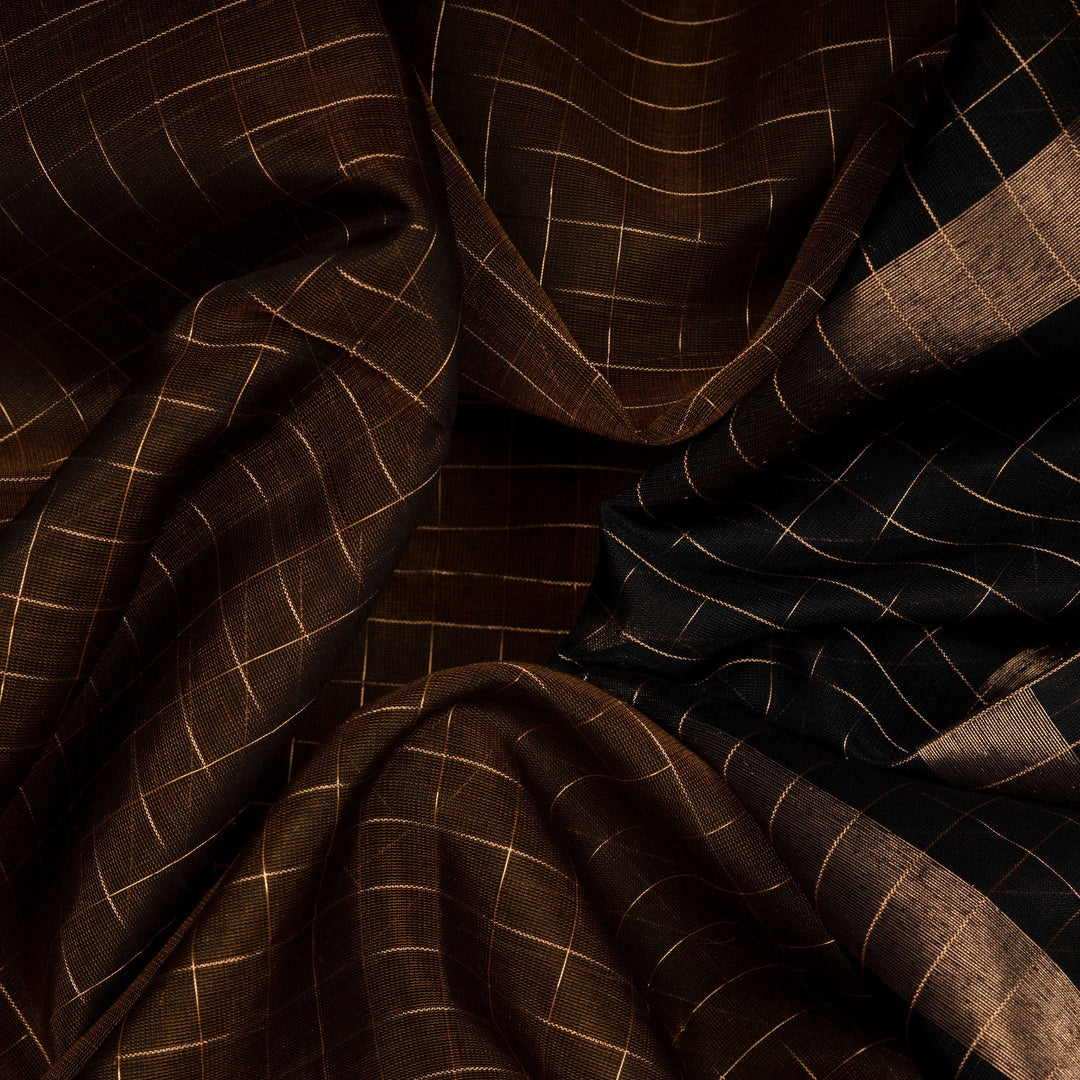 Closeup view of a Lightweight moss brown silk cotton saree with black gold zari border, checks, paisleys, temple and chevron motifs.