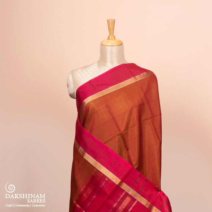 Full view of a Lightweight rust orange silk cotton saree with pink gold-silver zari border.