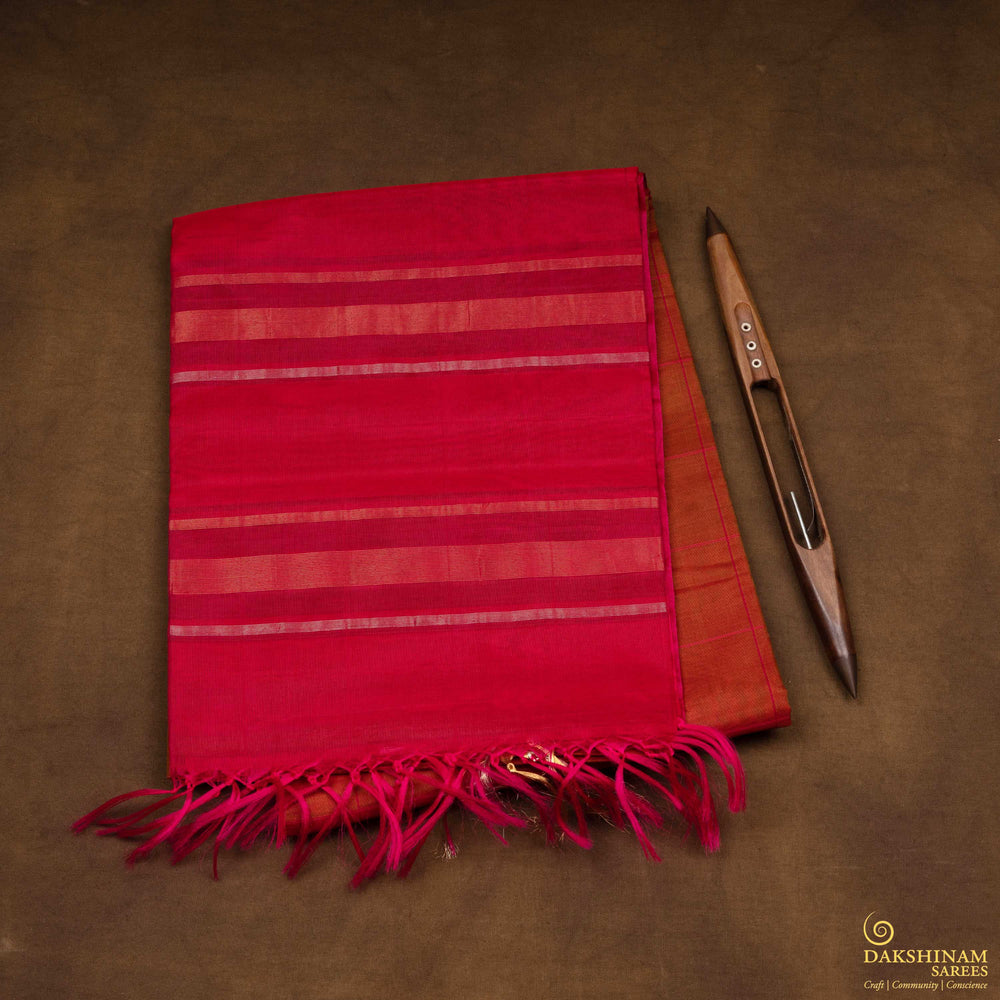 Closeup view of a Lightweight rust orange silk cotton saree with pink gold-silver zari border.