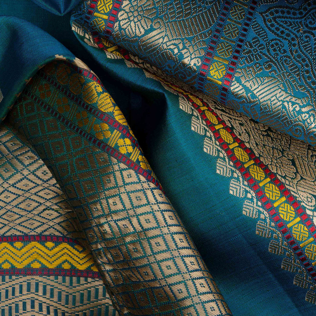 Closeup view of a Blue plain Kanjivaram silk saree with threadwork motifs.
