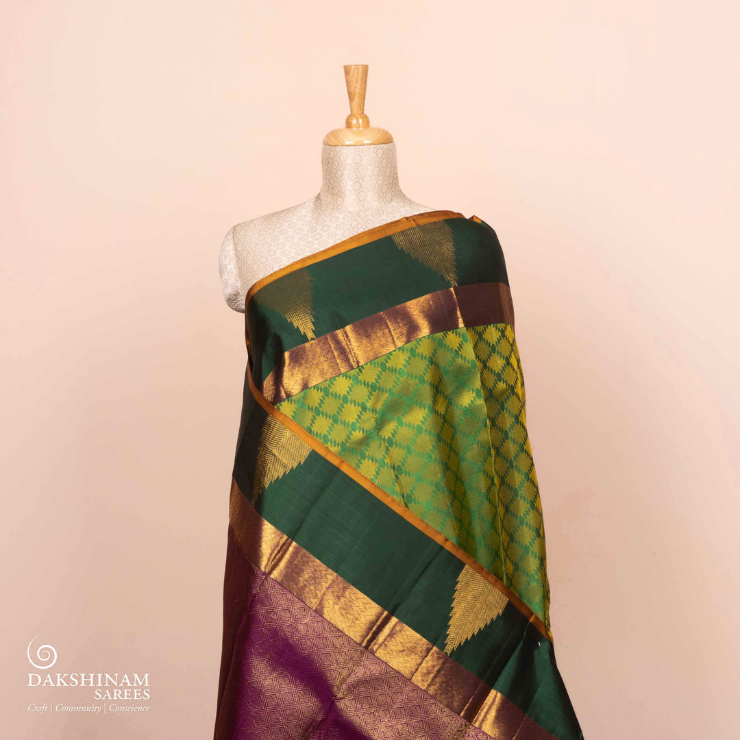 Full Body view of a Light green Kanjivaram silk saree with temple border and purple pallu.
