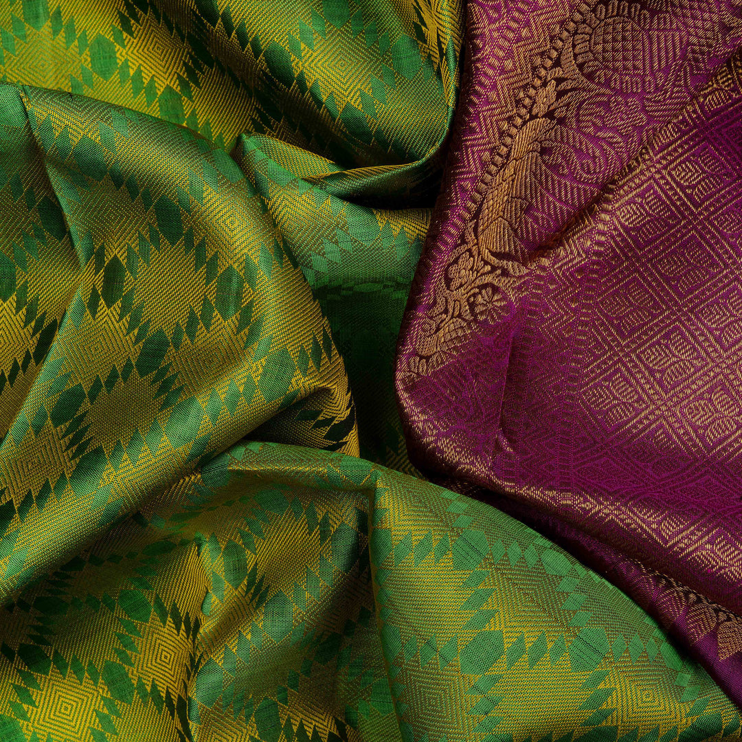 Closeup view of a Light green Kanjivaram silk saree with temple border and purple pallu.