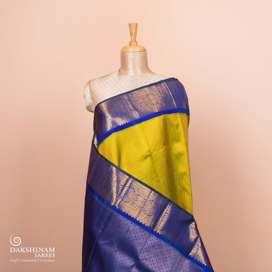 Full view of a Light green checked Kanjivaram silk saree with royal blue korvai border.