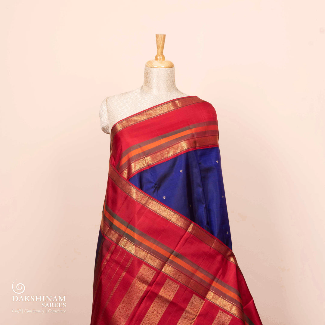 Full view of a Navy blue Kanjivaram silk saree with red korvai border.