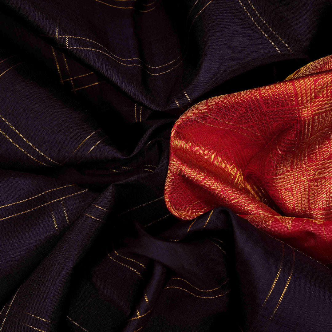 Body closeup view of a Midnight blue Kanjivaram silk saree with red korvai border and gold checks.