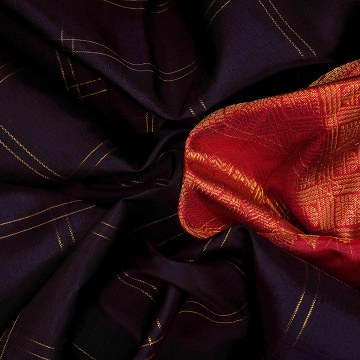 Body closeup view of a Midnight blue Kanjivaram silk saree with red korvai border and gold checks.