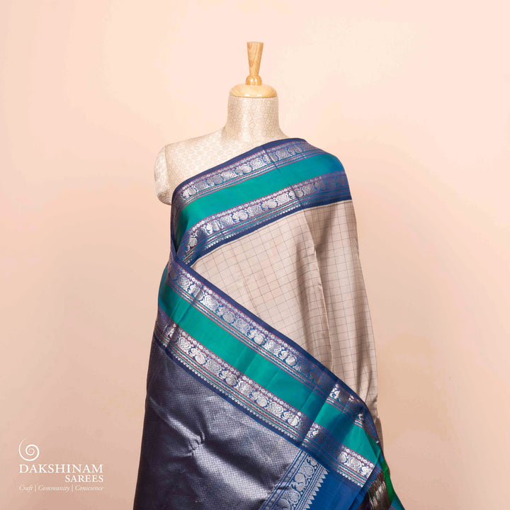 Full view of a Grey checked Kanjivaram silk saree with blue korvai border.