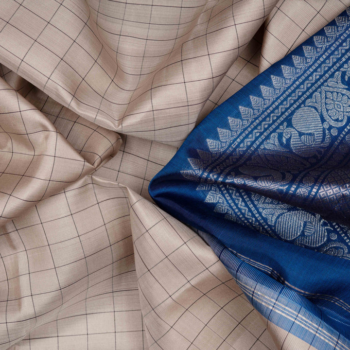 Body closeup of a Grey checked Kanjivaram silk saree with blue korvai border.