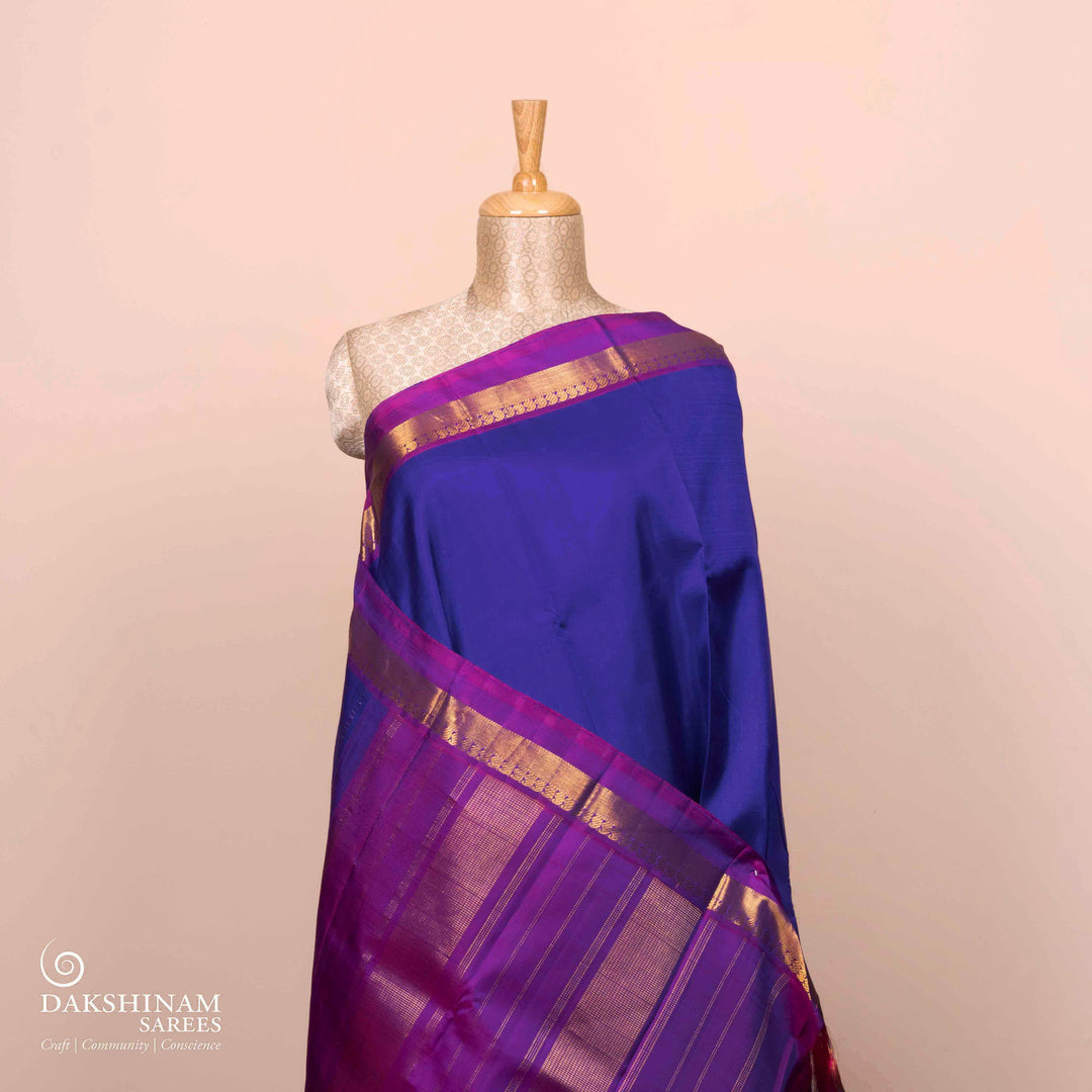 Full view of a Blue Kanjivaram silk saree with dark magenta border.