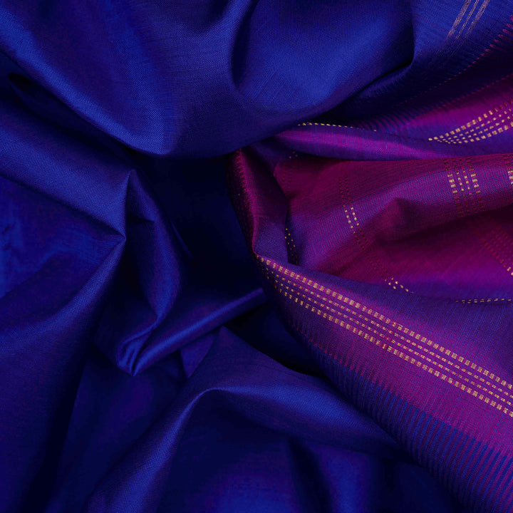 Body closeup view of a Blue Kanjivaram silk saree with dark magenta border.