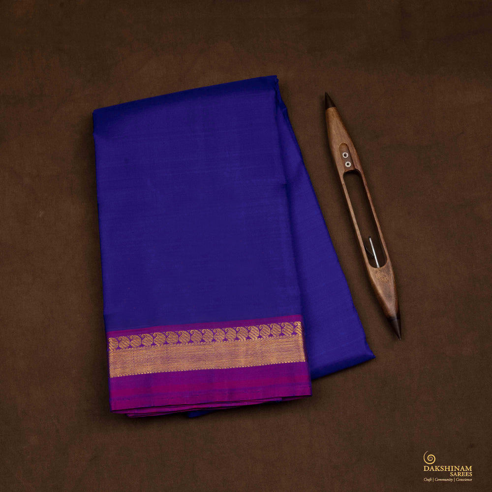 Closeup view of a Blue Kanjivaram silk saree with dark magenta border.