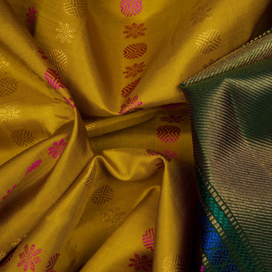 Body Closeup of a Yellow Korvai Kanjivaram silk saree with green border.