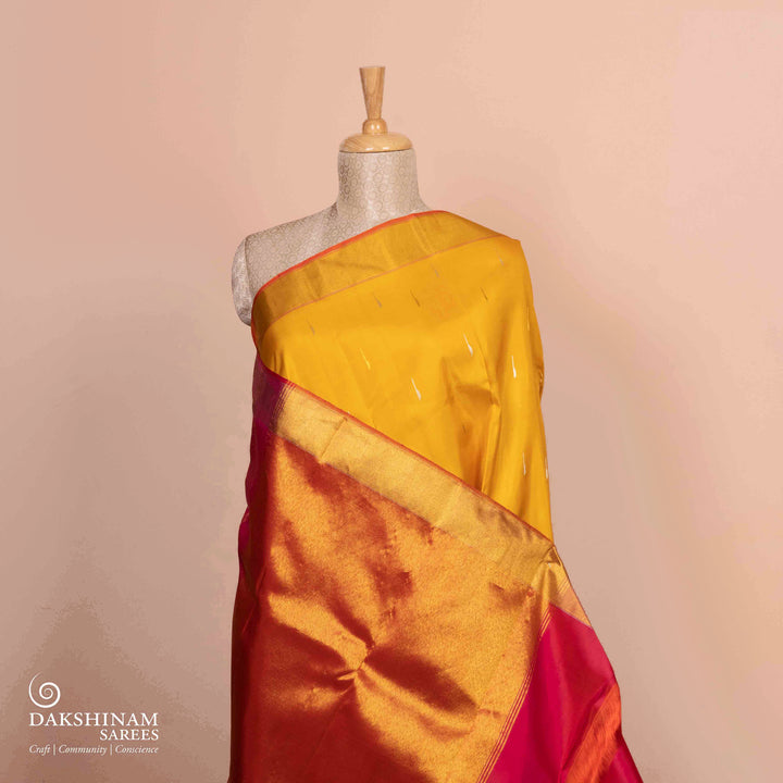 Full view of a Yellow Korvai Kanjivaram silk saree with red temple border.