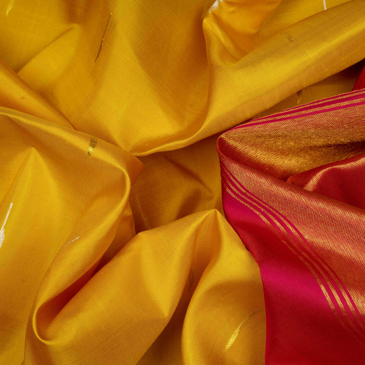 Body Closeup of a Yellow Korvai Kanjivaram silk saree with red temple border.