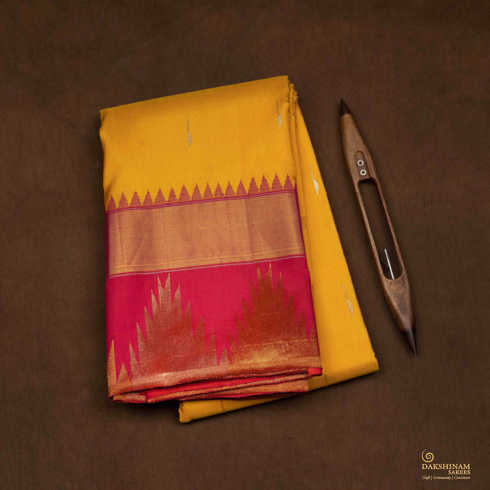 Closeup of a Yellow Korvai Kanjivaram silk saree with red temple border.