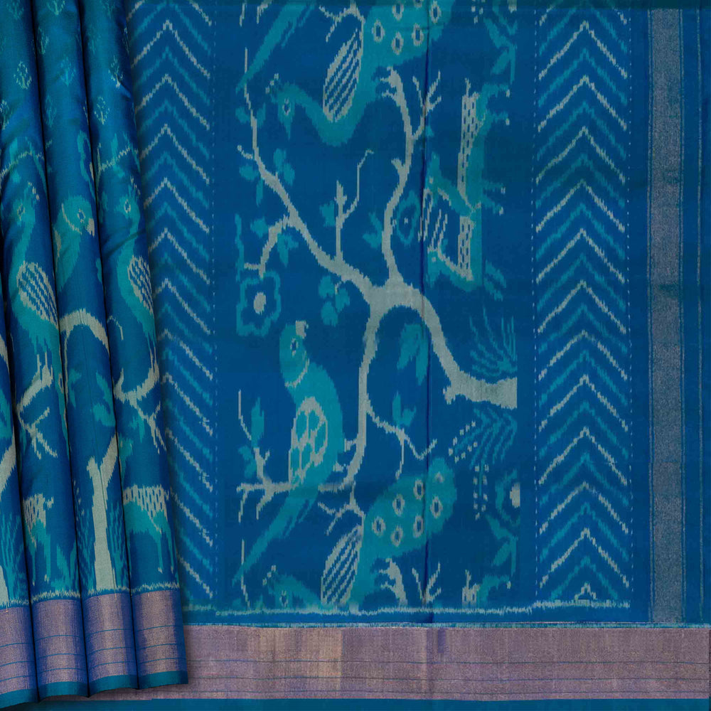 Blue fabric with bird and tree pattern of Handwoven Blue Ikat silk Saree