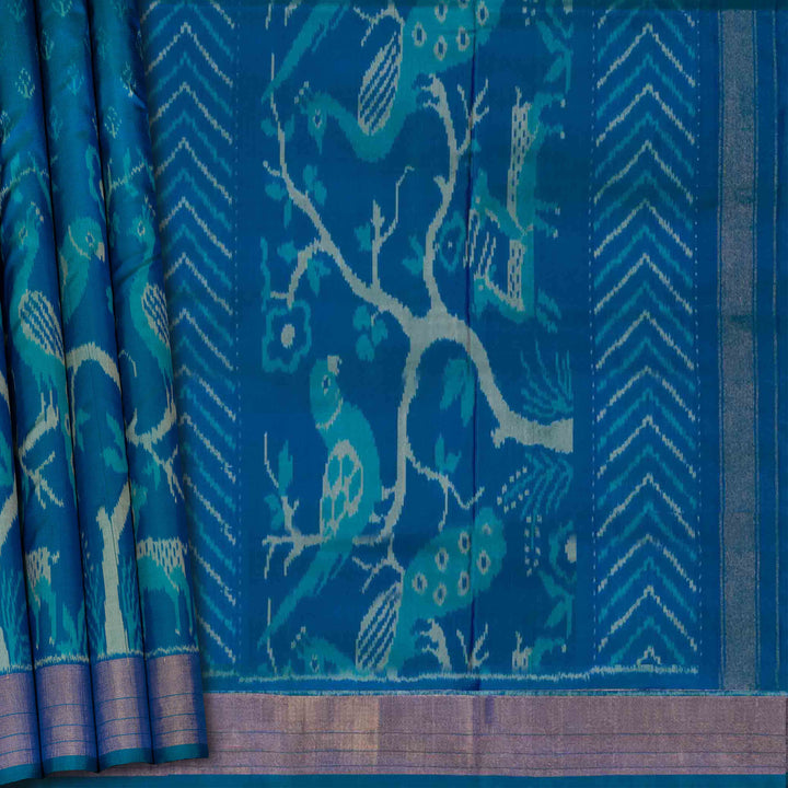 Blue fabric with bird and tree pattern of Handwoven Blue Ikat silk Saree