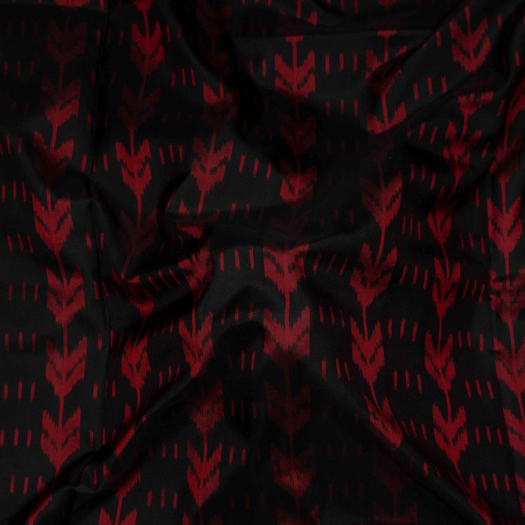 Blouse Closeup view of a Black Ikat silk saree with red border and floral diamond pallu.