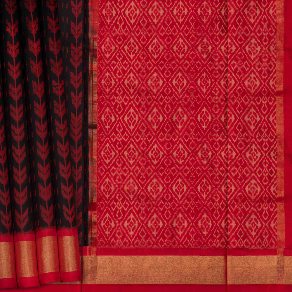 Closeup view of a Black Ikat silk saree with red border and floral diamond pallu.