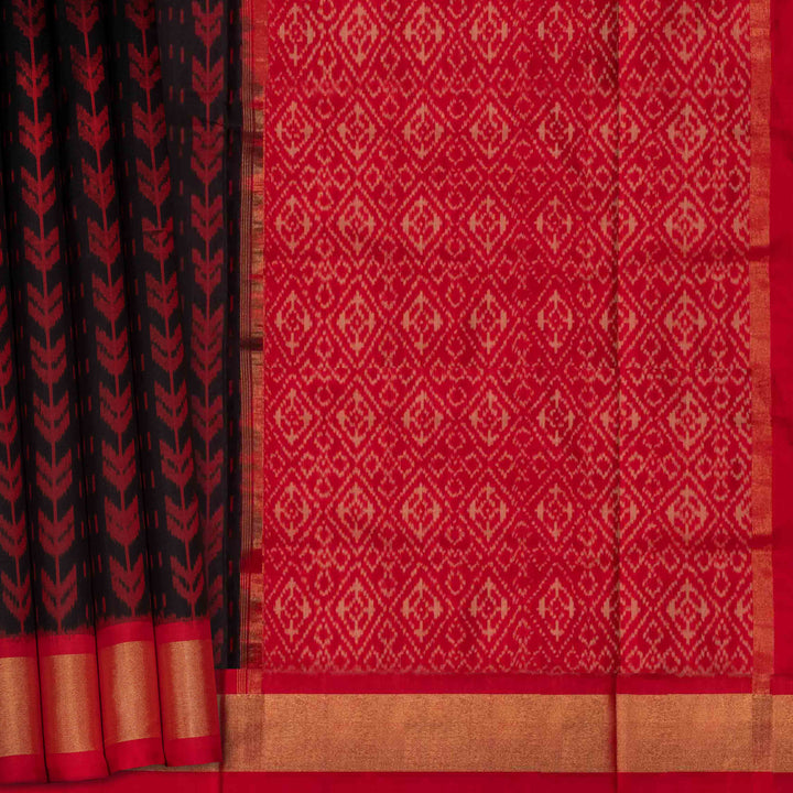 Closeup view of a Black Ikat silk saree with red border and floral diamond pallu.