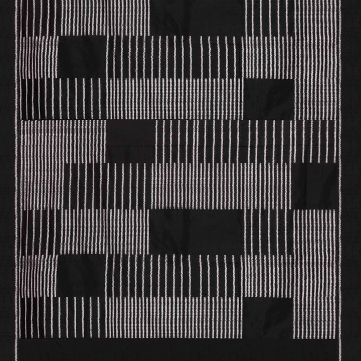 Close-up of a black and white geometric patterned double Ikat saree with striped body.