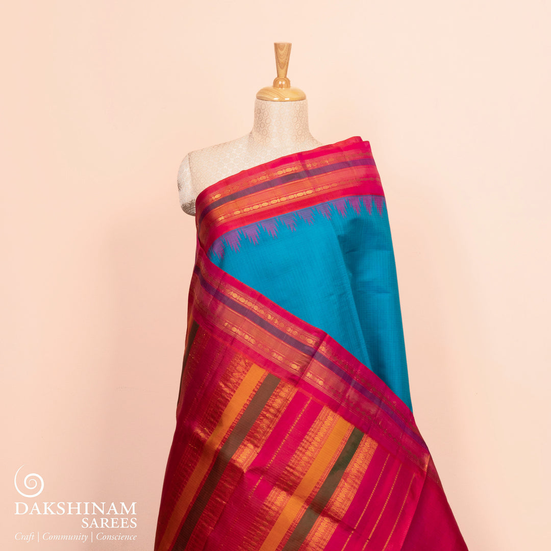 Full view of a Blue Gadwal silk cotton saree with red dual-tone border.