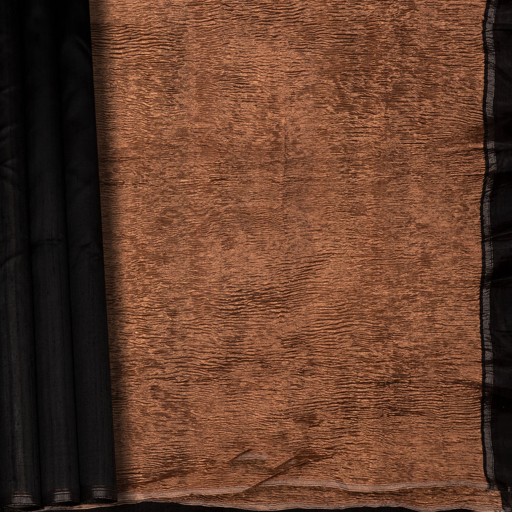 Closeup of a Black Dupion silk saree with copper tissue pallu.