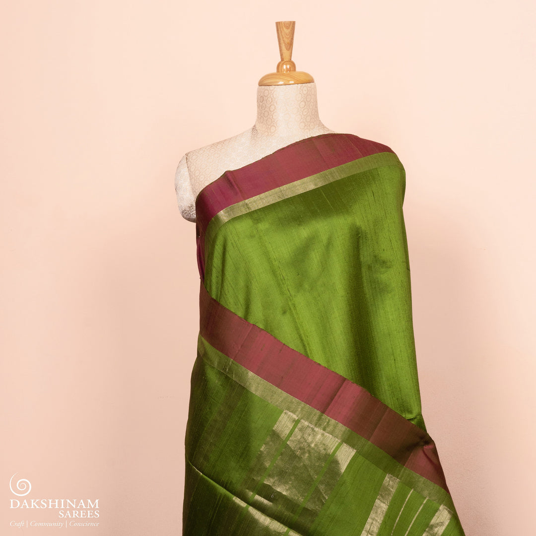 Full view of a Green Dupion silk saree with pink border and gold zari pallu.
